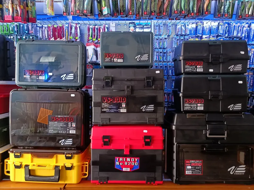 Stacked tackle boxes in black, red and yellow