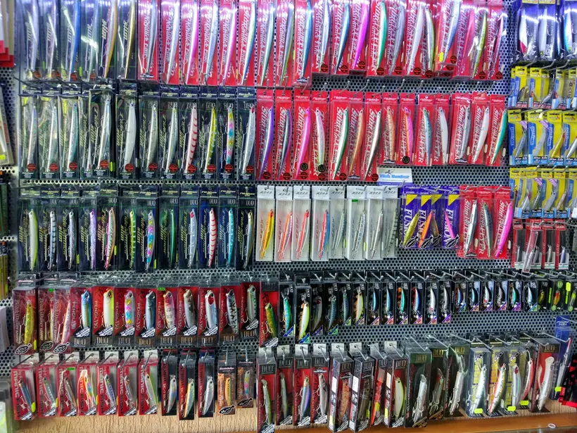 A full wall of hard lures in their packs