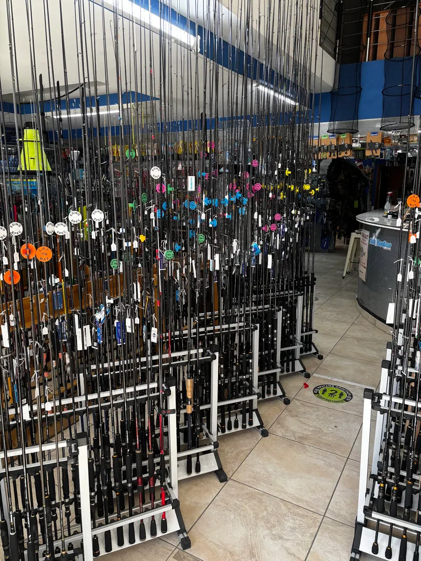 Rows of fishing rods standing in racks across the shop floor